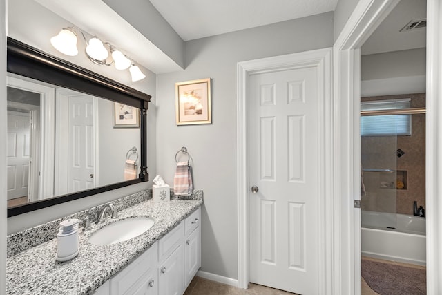 bathroom with vanity and tiled shower / bath combo