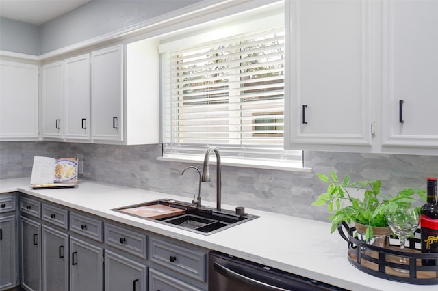 kitchen with white cabinets, backsplash, gray cabinets, and sink