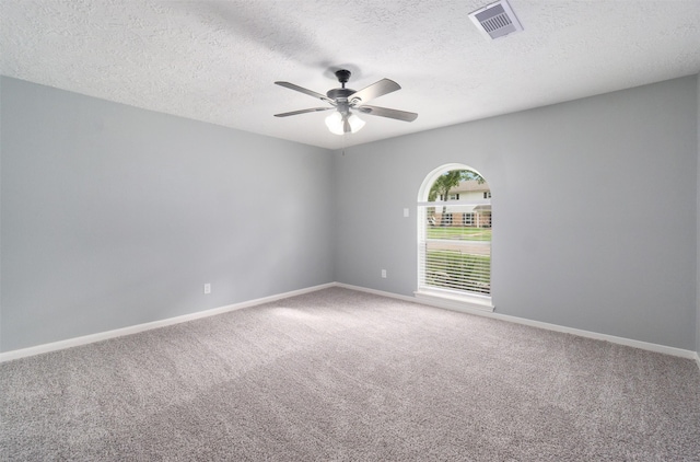 spare room with carpet flooring, a textured ceiling, and ceiling fan