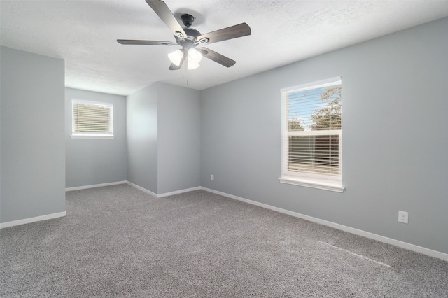 empty room featuring carpet flooring, ceiling fan, and a textured ceiling