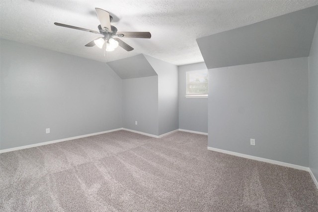 bonus room with carpet, a textured ceiling, ceiling fan, and lofted ceiling