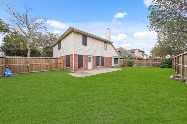 rear view of house featuring a patio and a yard