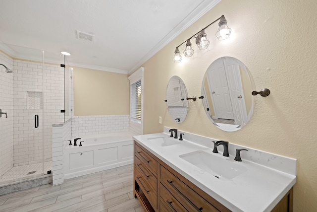 bathroom featuring vanity, shower with separate bathtub, hardwood / wood-style floors, and crown molding