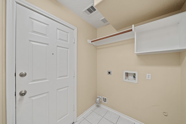 clothes washing area featuring washer hookup, light tile patterned floors, and electric dryer hookup