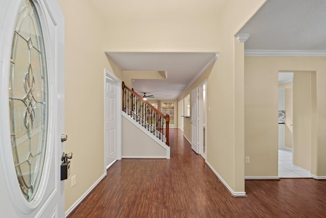 entryway with ornamental molding, wood-type flooring, and ornate columns