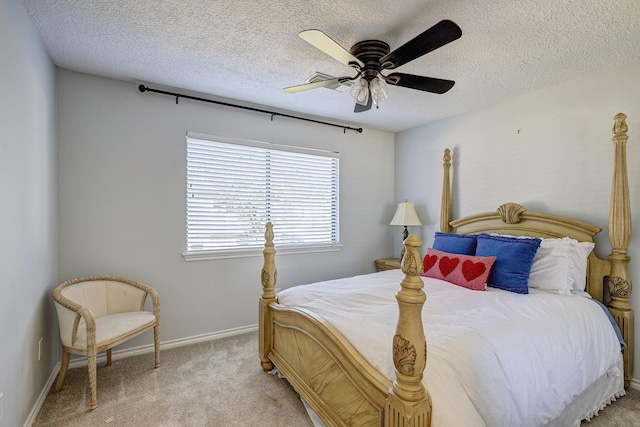 carpeted bedroom with ceiling fan and a textured ceiling