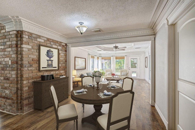 dining room featuring a textured ceiling, dark hardwood / wood-style flooring, ceiling fan, and ornamental molding