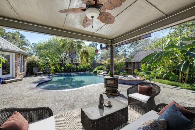 view of pool with a patio area, ceiling fan, and a jacuzzi