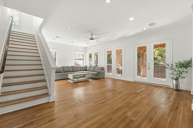 living room featuring french doors, ceiling fan, a healthy amount of sunlight, and hardwood / wood-style floors