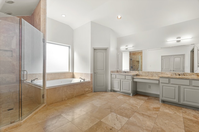 bathroom featuring vanity, lofted ceiling, and independent shower and bath