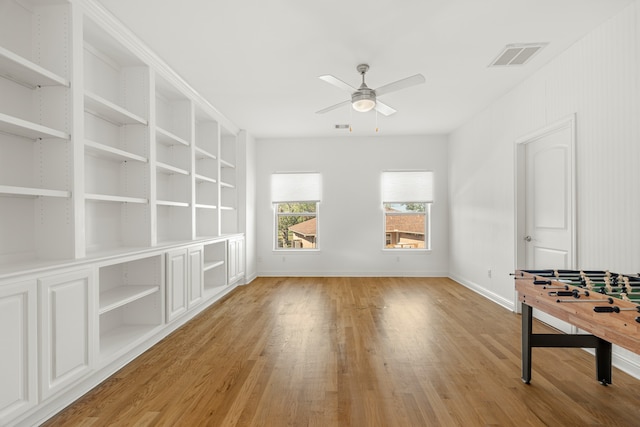 spare room with ceiling fan and light wood-type flooring