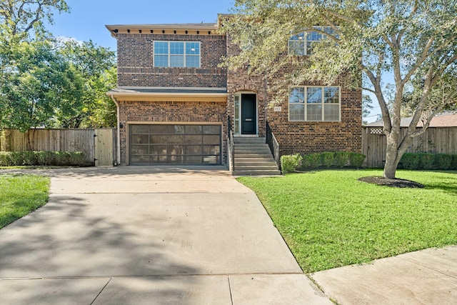 view of front of house featuring a garage and a front lawn