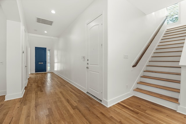 hall featuring a wealth of natural light and light hardwood / wood-style floors