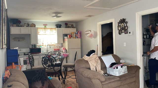 living room with light hardwood / wood-style flooring and sink