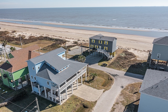 bird's eye view featuring a water view and a beach view