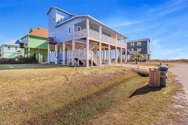 rear view of property with central AC and a yard