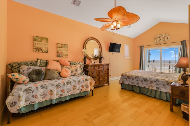 bedroom featuring light hardwood / wood-style floors, ceiling fan, vaulted ceiling, and access to outside