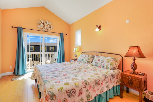 bedroom featuring access to outside, lofted ceiling, and hardwood / wood-style flooring