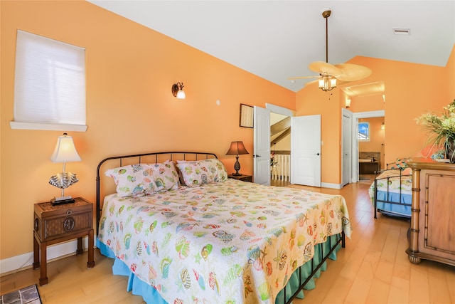 bedroom with light wood-type flooring, vaulted ceiling, and ceiling fan