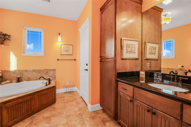 bathroom featuring vanity, a bath, and tile patterned flooring