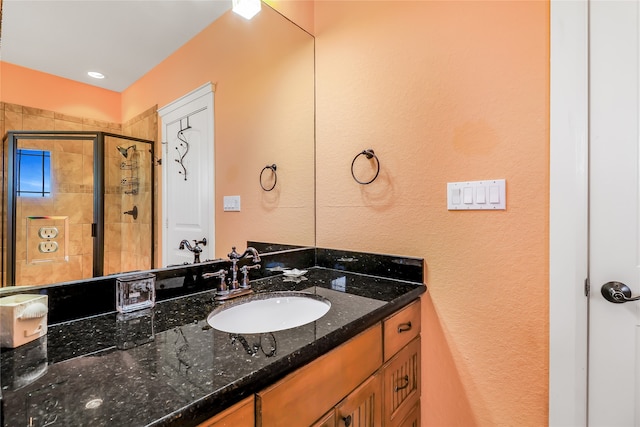 bathroom featuring walk in shower and vanity