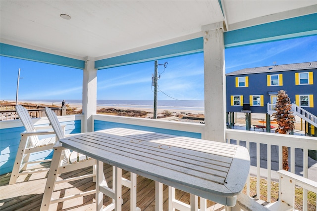 sunroom / solarium featuring a water view