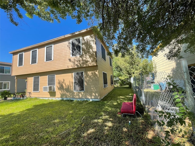 view of side of property with a lawn and cooling unit