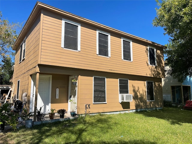 back of house with cooling unit and a yard