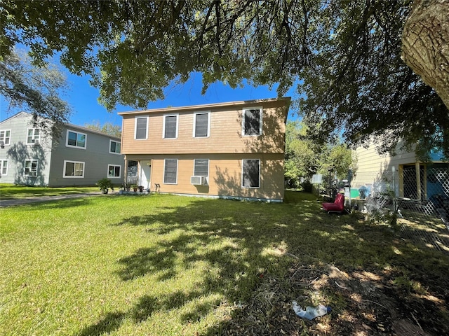 back of property featuring cooling unit and a yard