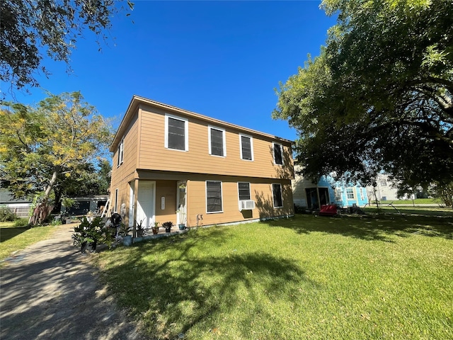 view of front of house featuring cooling unit and a front lawn