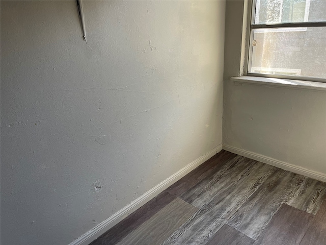 empty room featuring dark hardwood / wood-style flooring