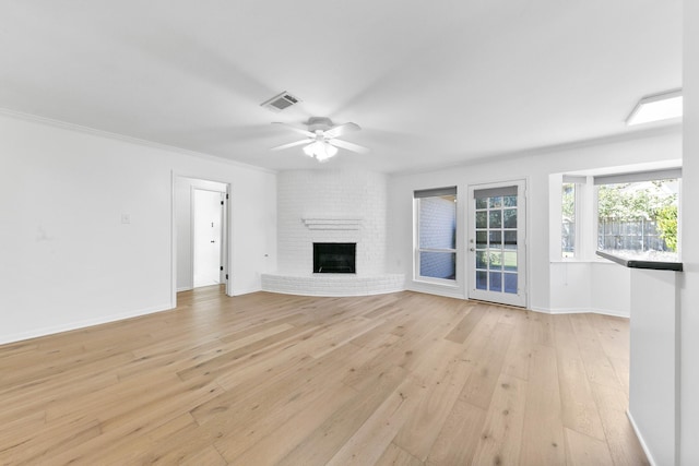 unfurnished living room featuring a fireplace, light hardwood / wood-style floors, ceiling fan, and ornamental molding