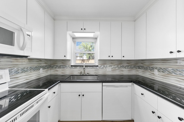 kitchen with white appliances, sink, decorative backsplash, ornamental molding, and white cabinetry