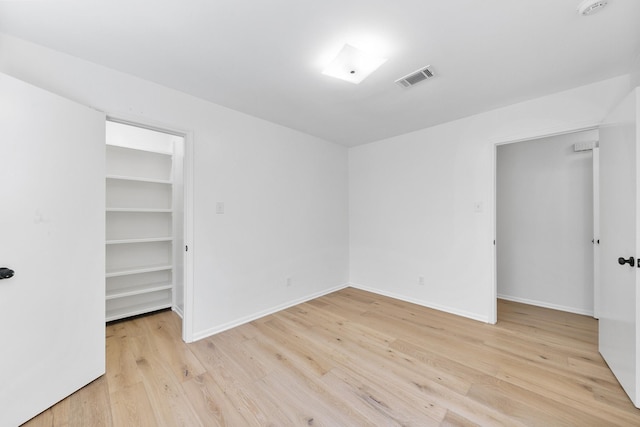 spare room featuring light hardwood / wood-style flooring