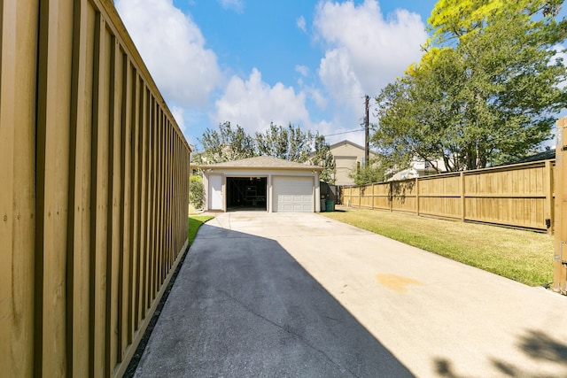 exterior space featuring a lawn, an outdoor structure, and a garage