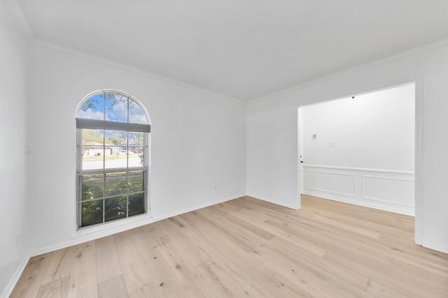 unfurnished room featuring light wood-type flooring and ornamental molding