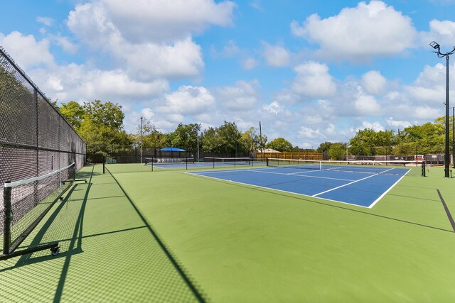 view of tennis court featuring basketball court