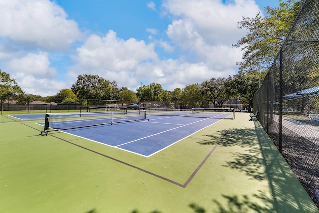 view of tennis court featuring basketball hoop