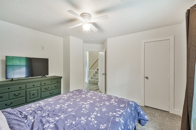 bedroom featuring light colored carpet and ceiling fan