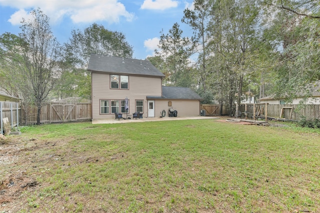 rear view of house with a patio area and a yard