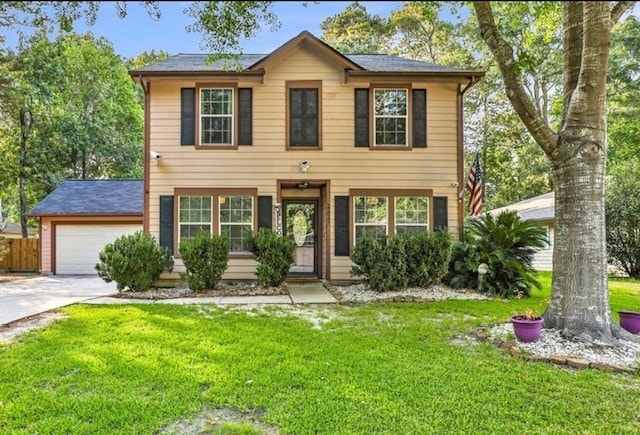 colonial home with a garage and a front yard