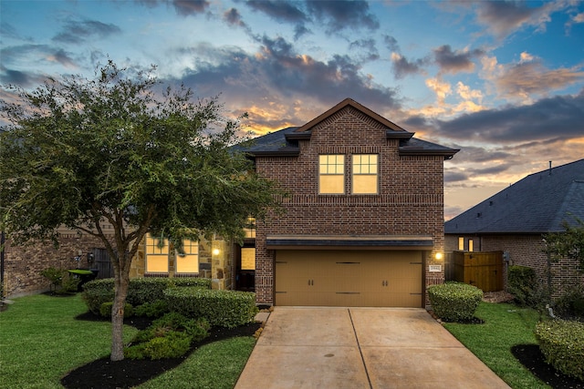 view of front facade featuring a garage and a lawn