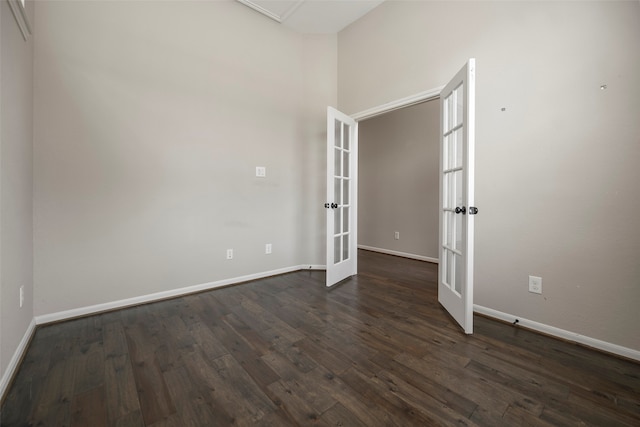 empty room featuring french doors and dark hardwood / wood-style floors