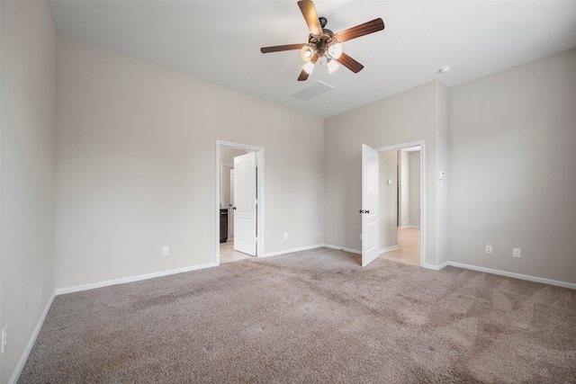 empty room featuring light carpet and ceiling fan