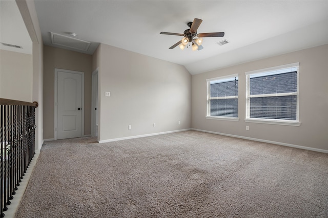 spare room featuring vaulted ceiling, carpet flooring, and ceiling fan