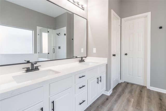 bathroom featuring wood-type flooring, vanity, and an enclosed shower