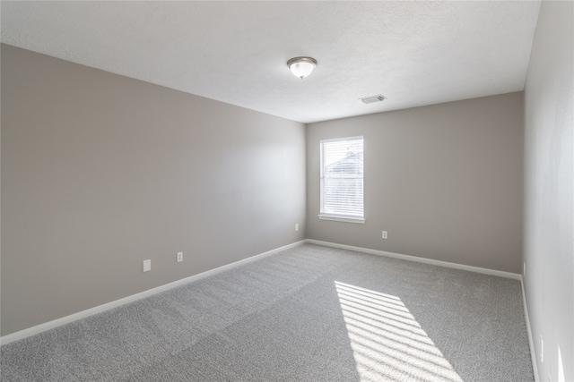 unfurnished room with carpet floors