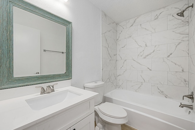 full bathroom featuring vanity, a textured ceiling, toilet, and tiled shower / bath