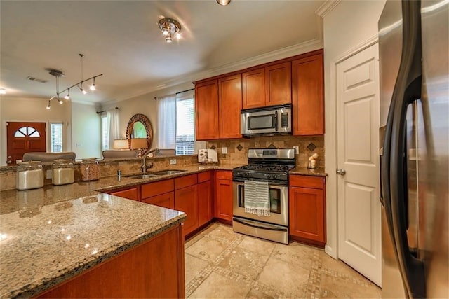 kitchen featuring ornamental molding, stainless steel appliances, backsplash, stone countertops, and sink