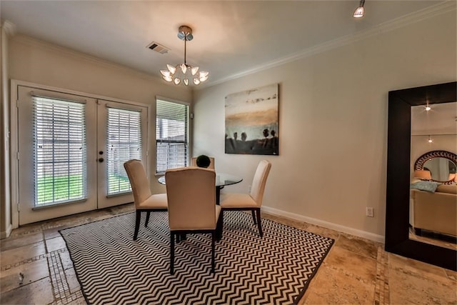 dining space featuring ornamental molding, french doors, and a chandelier